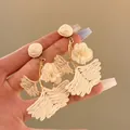 Hand-held raffia ginkgo leaf and fabric flower drop earrings in creamy white finish - White