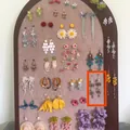 Various Mori-style handmade earrings featuring floral, butterfly, and tassel designs on display. - Size 7