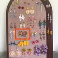Detailed view of handmade colorful beaded hoop earrings on a jewelry organizer board - 14#