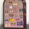 Detail view of elegant purple layered flower earrings on a jewelry display board. - 15#