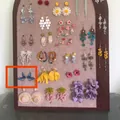 Detail view of blue butterfly drop earrings displayed on a felt board - 17#