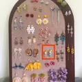 Detailed view of colorful floral and butterfly tassel earrings on a display board - 18#