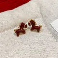 Close-up of elegant burgundy enamel horse stud earrings with high-quality gold plating - Pony Style (WE5185) / Red