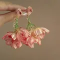 Elegant pink raffia flower pendant earrings with green beaded accents in a beach vacation style. - 49# Pink Gold Raffia Gradient Petal Style