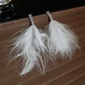 Elegant white feather tassel earrings featuring sparkling zirconia stones on silver studs - Silver Earring Post Style / White