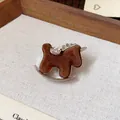 Close-up of a brown flocked rocking horse brooch with sparkling rhinestone accents - Rocking Horse Brooch / Brown - Flocked