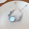 Elegant woven rope watch bracelet with blue ceramic beads on a white plate. - Bracelet Style / Blue/Coffee