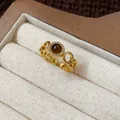 Close-up view of a gold-plated tiger eye ring with vintage aesthetic in a jewelry box - 2# Ring-Gold-Brown (Real Gold Plated)-Zirconia Border