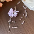 Close-up detail of elegant purple fabric flower necklace with delicate crystal beads - Pink Purple