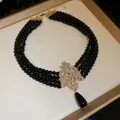Elegant vintage multi-strand black bead choker necklace with ornate crystal drop pendant - Black