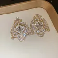 Elegant vintage gold-tone palace style chandelier earrings with sparkling rhinestones - Gold