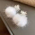 Detailed close-up of white fluffy pompom earrings with elegant silver starburst design - Silver Earring Post Style / White