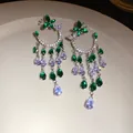Detailed macro view of zircon butterfly earrings with cascading teardrop tassels - Butterfly Water Drop Tassel Style (HE27657) / Silver-Green