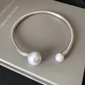 Elegant silver spring open choker necklace with two white pearls on a grey background. - Spiral Beaded Open Choker (25#)