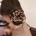 Close-up of a retro leopard print scrunchie styled in a messy bun hair arrangement. - Large Scrunchie / Coffee Leopard