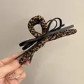Elegant vintage leopard print hair claw clip with a stylish black faux leather bow detail - Bow Claw Clip / Black-Coffee