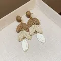 Detailed view of handmade raffia tiered heart leaf earrings in natural brown and beige - Long Style (HE30706) / Brown