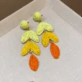 Close-up of handmade raffia heart drop earrings with vibrant dopamine color gradients - Long Style (HE30706) / Yellow