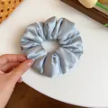 Large soft blue satin hair scrunchie for elegant styling and comfortable ponytail - Satin Scrunchie / Blue