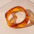 Close-up view of a unique amber resin irregular bangle featuring retro tortoise shell swirls - Style 3 - Coffee Color