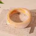 Detail showing the irregular shape and orange marbled pattern of the resin bangle - Smudged Marble Style (4#) / Beige