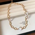 Palace style gold oval hollow necklace with white enamel detail in cream jewelry box - Gold-White