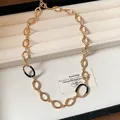 Elegant vintage gold-tone oval hollow link necklace with black drip oil enamel details - Gold-Black