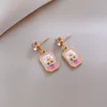 Elegant gold-tone drop earrings featuring pink enamel with a clover pattern detail - 107 Silver Needles - Gold - Pink