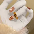 Detailed view of a vintage 18k gold plated star ring with tiger eye and zircon - Gold Brown