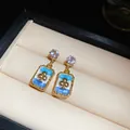 Elegant gold-plated geometric earrings featuring blue enamel and a clover design detail - 108 Silver Needles - Gold - Blue