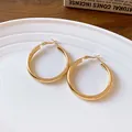 Elegant polished gold hoop earrings with French vintage style shown on white plate - Gold Hoop Style (HE13225)