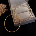 Minimalist minimalist gold thin hoop earrings with hammered texture presented in a gray jewelry box - Style 24 / 5cm / Gold