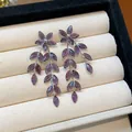 Close-up of purple glass flower and leaf tassel earrings in a cream jewelry box - Silver Earring Post Style / Purple