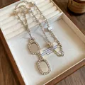 Macro detail of a silver eyeglasses pendant necklace with sparkling stones in a wooden box - Silver