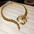 Macro detail view of a gold scorpion necklace with sparkling rhinestone accents - Gold