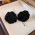 Close-up detail of vintage French style black fabric rose flower accessories - Earrings / Black
