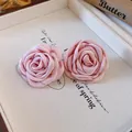 Close-up of pink fabric rose petals showing intricate texture and French sweet style - Earrings / Pink