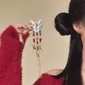 Close-up of elegant butterfly hair clip with colorful beads and long gold tassels - Duckbill Hair Clips / 1 Piece / Blue White Gradient Butterfly Tassel