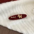 Macro shot of a red velvet duckbill hair clip with a gold poodle and Handmade charm - Dog Shape Duckbill Clip / 1 Piece / Wine Red Flocking Handmade