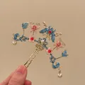 Detail view of a traditional Chinese hair stick with blue enamel flowers and pink butterflies - Hair Stick / 1 Piece / Gold Pink Blue Butterfly