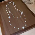 Elegant French vintage style layered pearl necklace with irregular beads on wooden tray - Silver-Grey