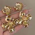 Macro close-up view of luxury gold floral drop earrings with intricate textured petals. - Large Flower Tassel (4#)