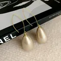 Close-up of elegant French style teardrop pearl earrings with golden curved hooks. - Waterdrop Hook / Earrings-Champagne