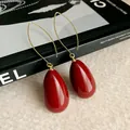 Close-up of elegant vintage-style red teardrop earrings with minimalist gold hooks - Waterdrop Hook / Ear Hook-Red
