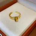Macro view of 18k gold plated ring with oval tiger eye stone and zircons - Single Oval Main Stone (HR2925) / Gold Brown