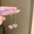 Detailed view of sparkling heart-shaped tassel earrings with shimmering crystal pavé - Heart Tassel Style (24#) / Gold