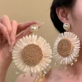 Detail view of oversized bohemian woven sunflower earrings with pearls and crystals - 13# Gold White Coffee