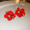 Elegant red floral stud earrings with textured gold accents and vintage French court style - Silver Earring Post - Red