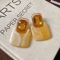 Detailansicht gelber Vintage-Kristallohrringe mit elegantem Marmor-Effekt aus Harz. - Gelb Rendering-Stil / Silbernadel / Gold