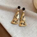 Detail view of new Chinese style gold earrings with pearls and black branch patterns - Floral Tassel Style / S925 Silver Needle - Gold - White - Black